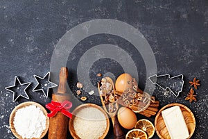 Bakery background with baking ingredients for christmas cooking top view. Flour, brown sugar, eggs and spices top view.