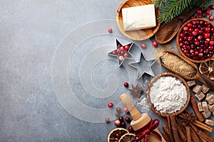 Bakery background with ingredients for cooking Christmas baking. Flour, brown sugar, butter, cranberry and spices on table top