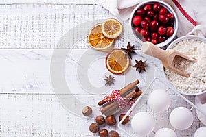 Bakery background with ingredients for cooking Christmas baking. Flour, brown sugar, cranberry and spices top view