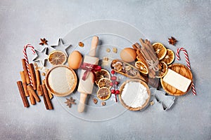Bakery background with ingredients for cooking christmas baking. Flour, brown sugar, eggs and spices on kitchen table top view.