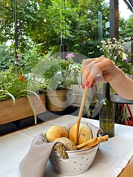 Basket with different types of fresh breads on the table.