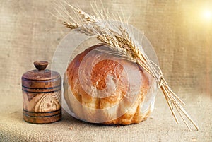 Bakery Bread and Sheaf of Wheat Ears. Still-life