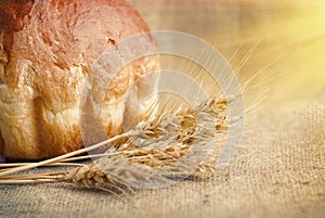 Bakery Bread and Sheaf of Wheat Ears. Still-life