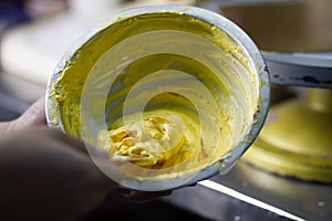 Bakery Chef Making a cream of cake in bowl at store