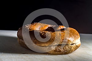 Bakery donut on a white donut with black background, copybspace and selective focus