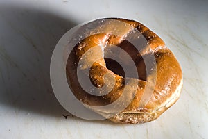 Bakery donut on a white donut with black background, copybspace and selective focus