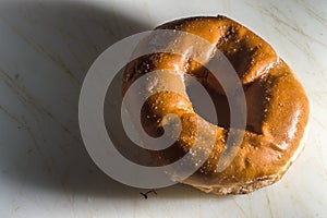 Bakery donut on a white donut with black background, copybspace and selective focus