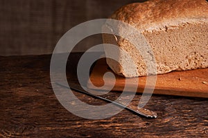 Bakery - gold rustic crusty loaves of bread and buns on black chalkboard background. Still life captured from above