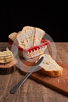 Bakery - gold rustic crusty loaves of bread and buns on black chalkboard background. Still life captured from above