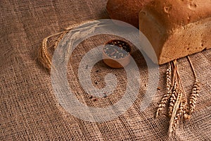 Bakery - gold rustic crusty loaves of bread and buns on black chalkboard background. Still life captured from above