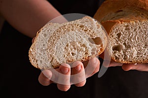 Bakery - gold rustic crusty loaves of bread and buns on black chalkboard background. Still life captured from above