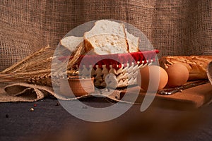 Bakery - gold rustic crusty loaves of bread and buns on black chalkboard background. Still life captured from above