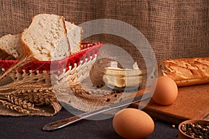 Bakery - gold rustic crusty loaves of bread and buns on black chalkboard background. Still life captured from above