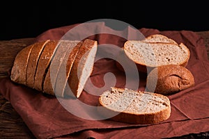 Bakery - gold rustic crusty loaves of bread and buns on black chalkboard background. Still life captured from above