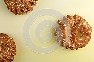 Bakery - gold rustic crusty loaves of bread and buns on textured background.