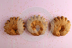 Bakery - gold rustic crusty loaves of bread and buns on textured background.