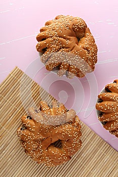 Bakery - gold rustic crusty loaves of bread and buns on textured background.