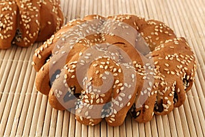 Bakery - gold rustic crusty loaves of bread and buns on textured background.