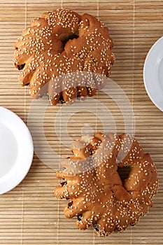 Bakery - gold rustic crusty loaves of bread and buns on textured background.