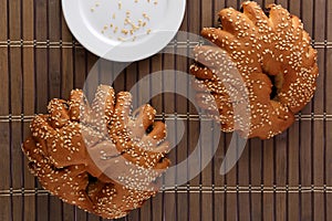 Bakery - gold rustic crusty loaves of bread and buns on textured background.