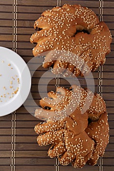 Bakery - gold rustic crusty loaves of bread and buns on textured background.