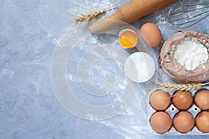 Bakery ingredients flour powder on stone background from above