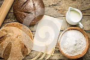 Bakery ingredients with fresh loaf of bread.