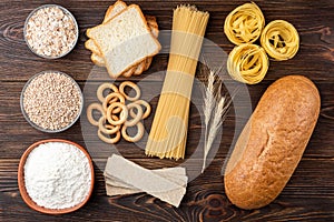 Bakery and pasta products on wooden. Baguette, pasta, dryings bagel, toast bread, crispbreads and bread.
