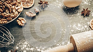 Bakery products. Cooking food ingredients: flour, eggs, nut and star anise, orange on dark table kitchen background for cake.