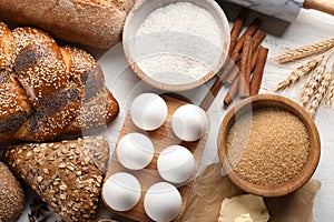 Bakery products with ingredients on wooden background