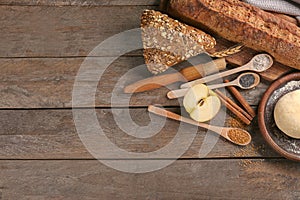 Bakery products with ingredients on wooden background