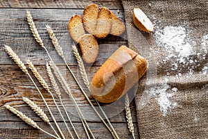 Bakery set with fresh wheaten bread on table rystic background top view