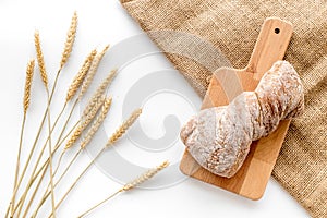 Bakery set with fresh wheaten bread on table white background top view