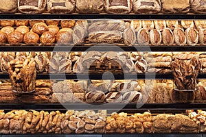 Bakery shelf with many types of bread. Tasty german bread loaves on the shelves