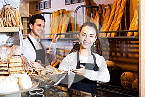 Bakery staff offering bread and different pastry