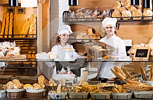 Bakery staff offering bread and different pastry