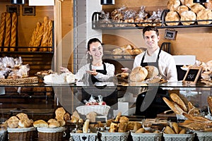 Bakery staff offering bread and different pastry