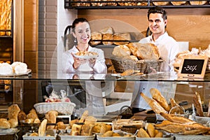 Bakery staff offering bread and different pastry