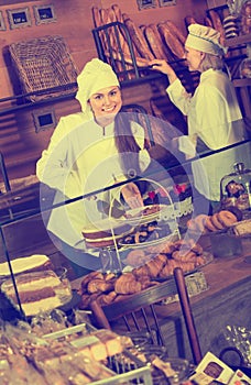 Bakery staff offering bread