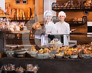 Bakery staff offering bread