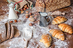 At the bakery, still life with mini Croissants, bread, milk, nuts and flour