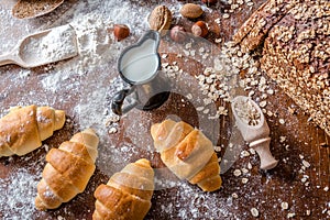 At the bakery, still life with mini Croissants, bread, milk, nuts and flour