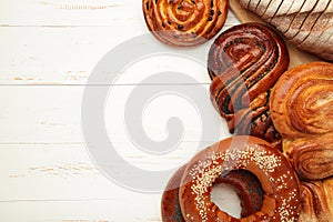 Bakery - various kinds of breadstuff. Bread rolls, bagel, sweet bun on white background. Space for text