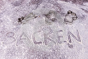 Baking Backen in German letters written in flour