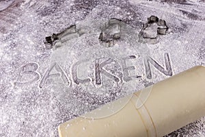 Baking Backen in German letters written in flour