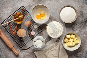 Baking background. Baking ingredients: flour, eggs, sugar, honey, butter, milk and spices on grunge background. Top view