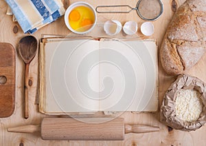 Baking background with blank cook book, eggshell, flour, rolling