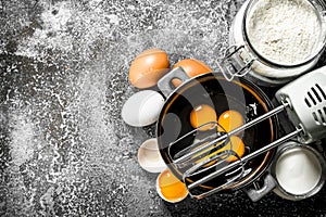 Baking background. Blend eggs with a mixer to make a dough.