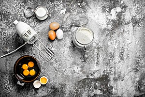 Baking background. Blend eggs with a mixer to make a dough.