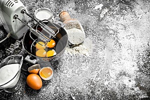 Baking background. Blend eggs with a mixer to make a dough.